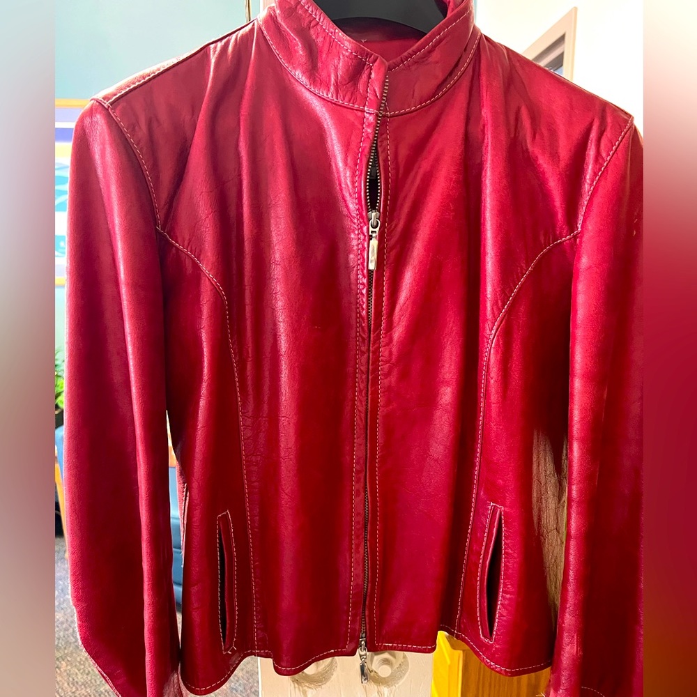 Used red Italian leather jacket.  U. S. Size small.  Jacket sits at the waist.